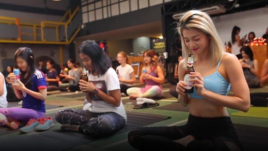 Women practising beer yoga