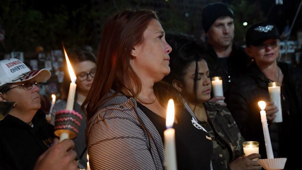 Heather Gooze, a survivor of the 2017 mass shooting at a Las Vegas music festival that spurred the intial bump stock ban, attends a gun violence vigil in 2018.