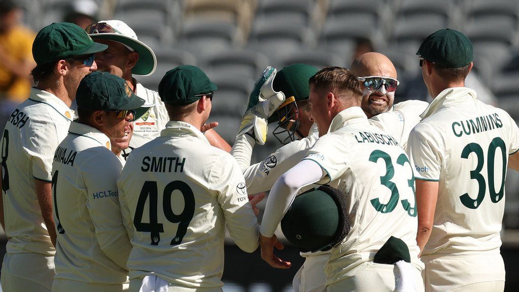 Nathan Lyon is congratulated by his Australia teammates after taking his 500th career Test wicket against Pakistan in Perth