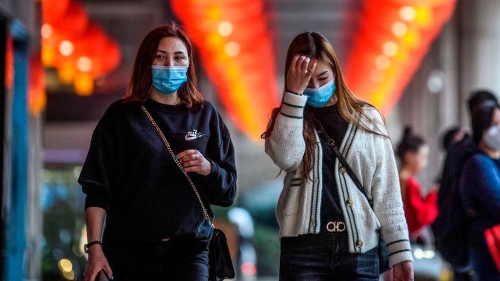 Pedestrians wear facemasks in Macau