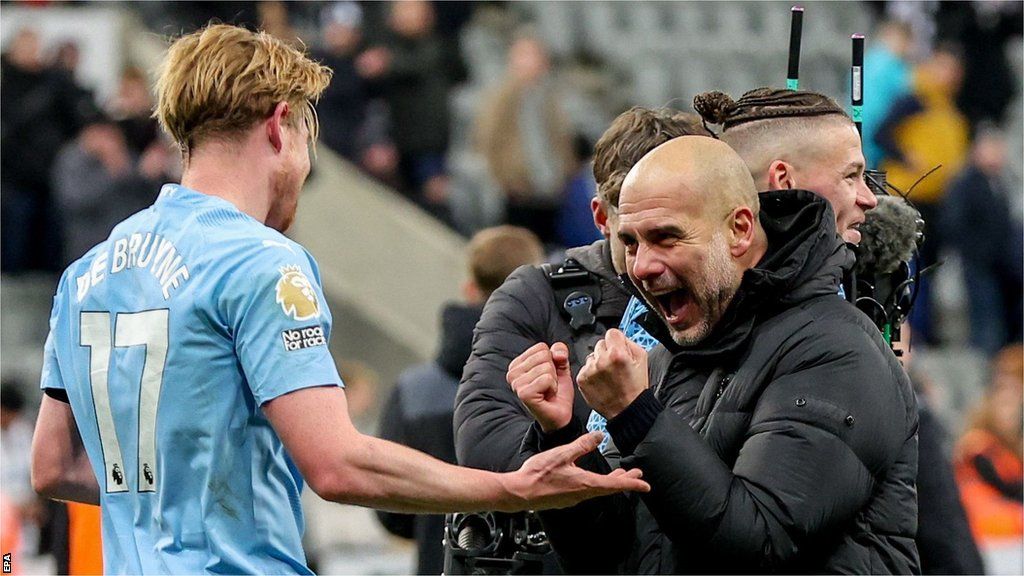 Kevin de Bruyne and Manchester City boss Pep Guardiola celebrate after beating Newcastle