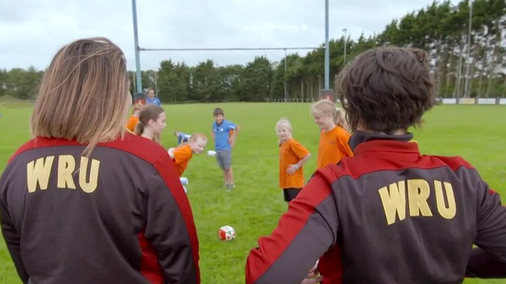 Wales international Sioned Harries and Shona Powell-Hughes watch a rugby training session with kids