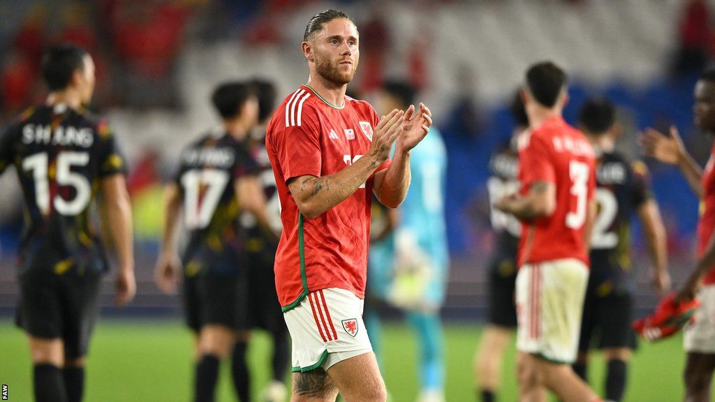 Wes Burns claps the fans after Wales' draw with South Korea