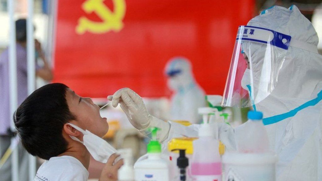 A child receives a nucleic acid test for the Covid-19 coronavirus in Yangzhou, in China's eastern Jiangsu province on 5 August 2021.