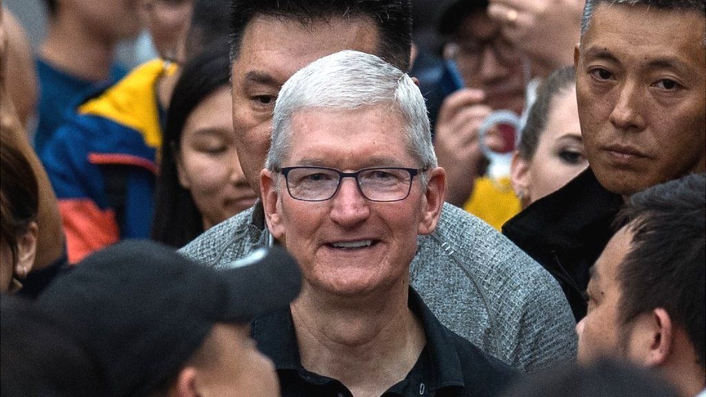 Tim Cook, centre, is mobbed during his visit to an Apple Store in Chengdu, China