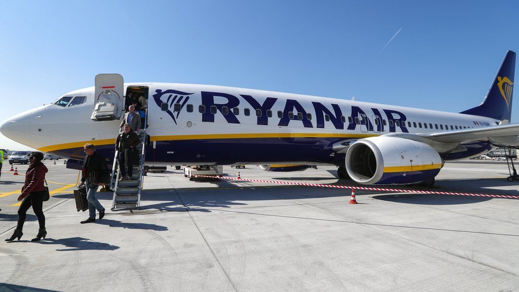 Passengers disembark Ryanair plane