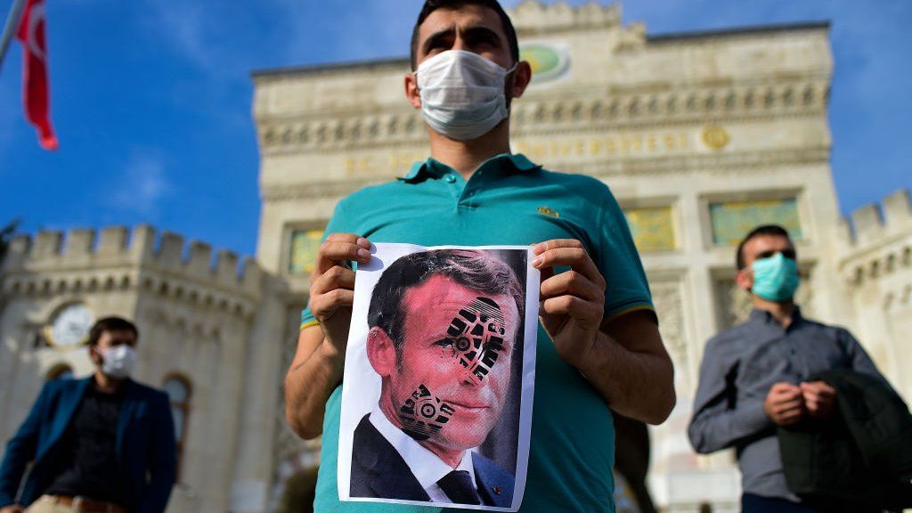 A Turkish man holds a poster of Emmanuel Macron during an anti-France protest