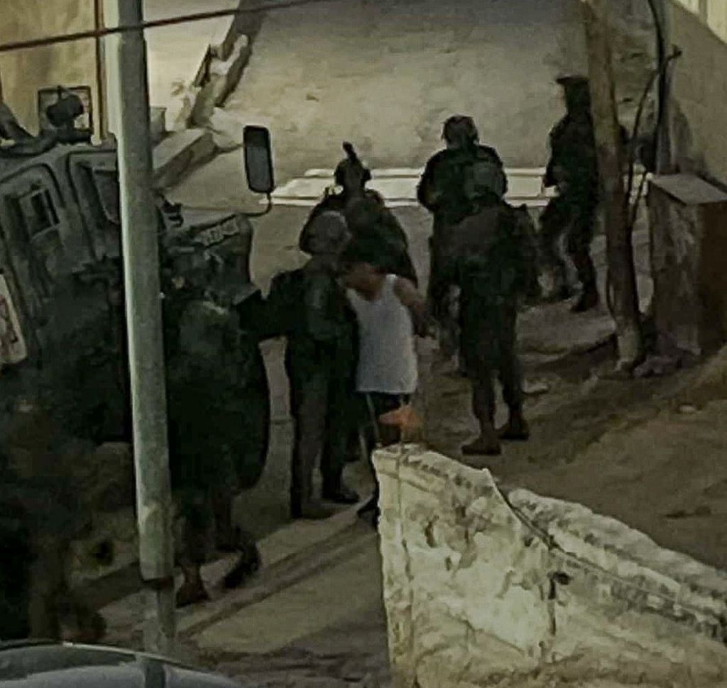 A photograph taken by Musa Aloridat's parents shows him being detained by the IDF following an early-morning raid