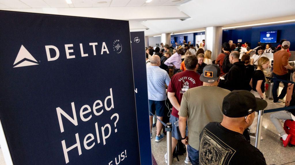 Travelers wait in line at check-in in Terminal 2, Delta Airlines, at Los Angeles airport, on July 19, 2024. 