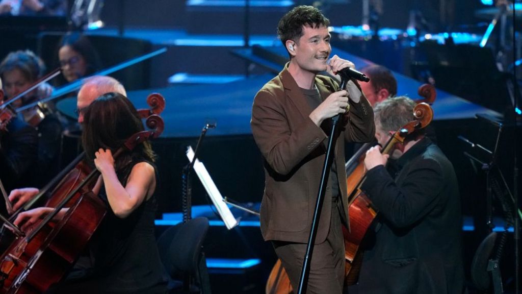Dan Smith on stage with the BBC Concert Orchestra at Sir David Attenborough's 100th birthday concert