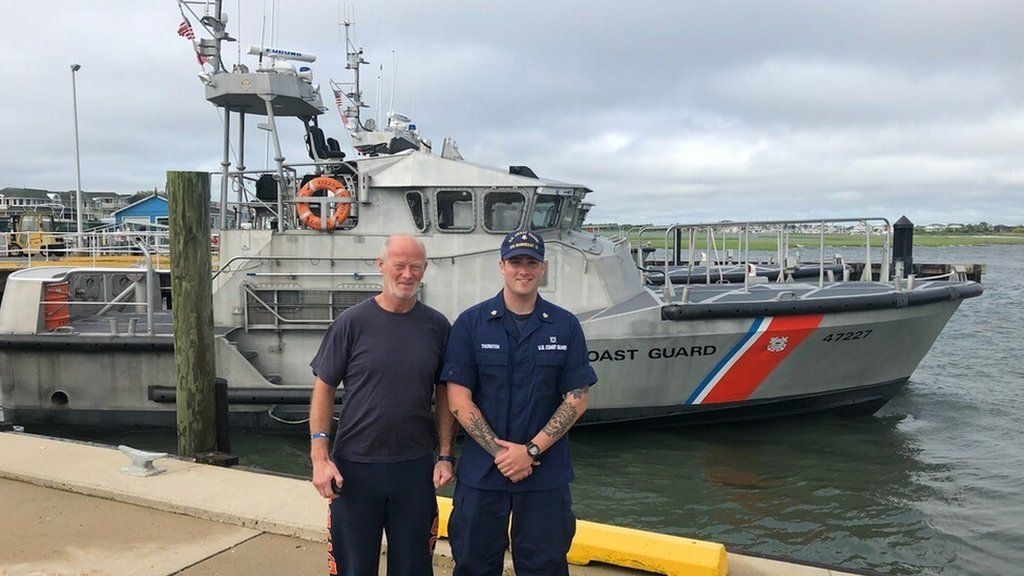 Duncan Hutchison with Petty Officer 2nd Class Eric Thornton, a surfman at Coast Guard Station Barnegat Light, poses for a photo with Duncan Hutchison