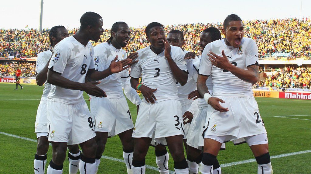 Asamoah Gyan celebrates a goal for Ghana with his teammates