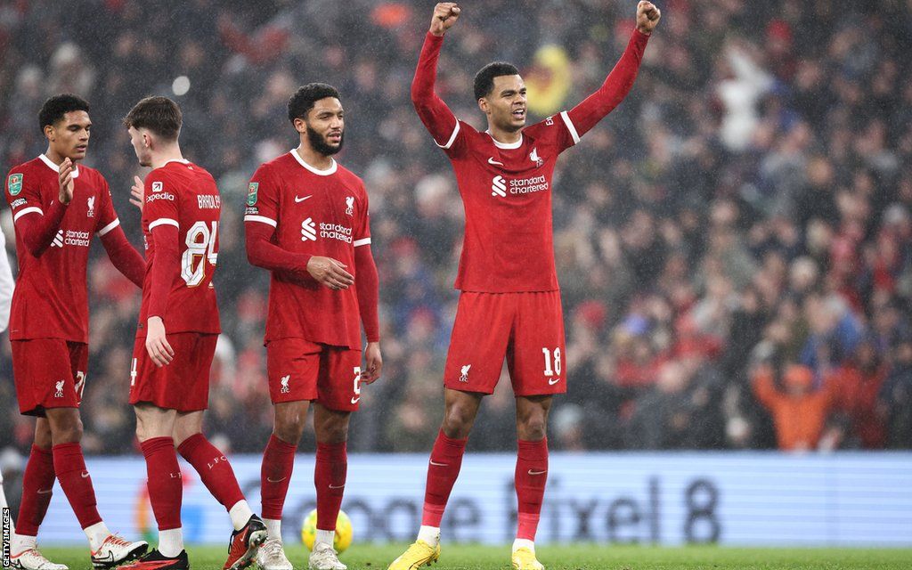 Liverpool players celebrate in front of the Kop