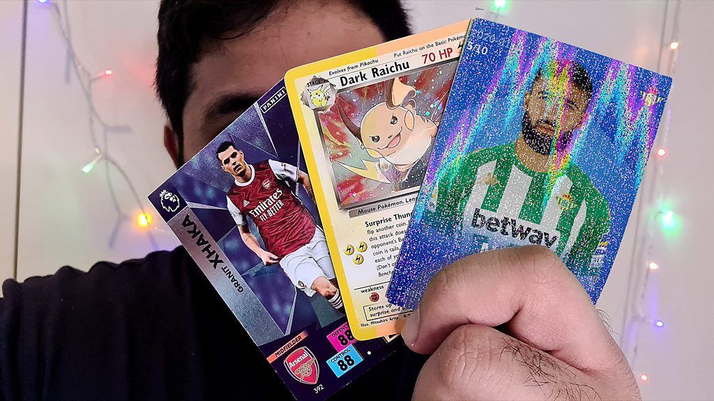 Reporter Omar Mehtab holds some trading cards