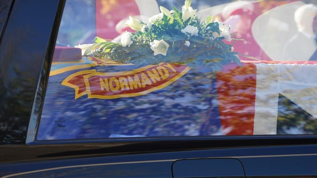 Cyril Elliott's coffin was covered by a flag embroidered with 'Normandy'