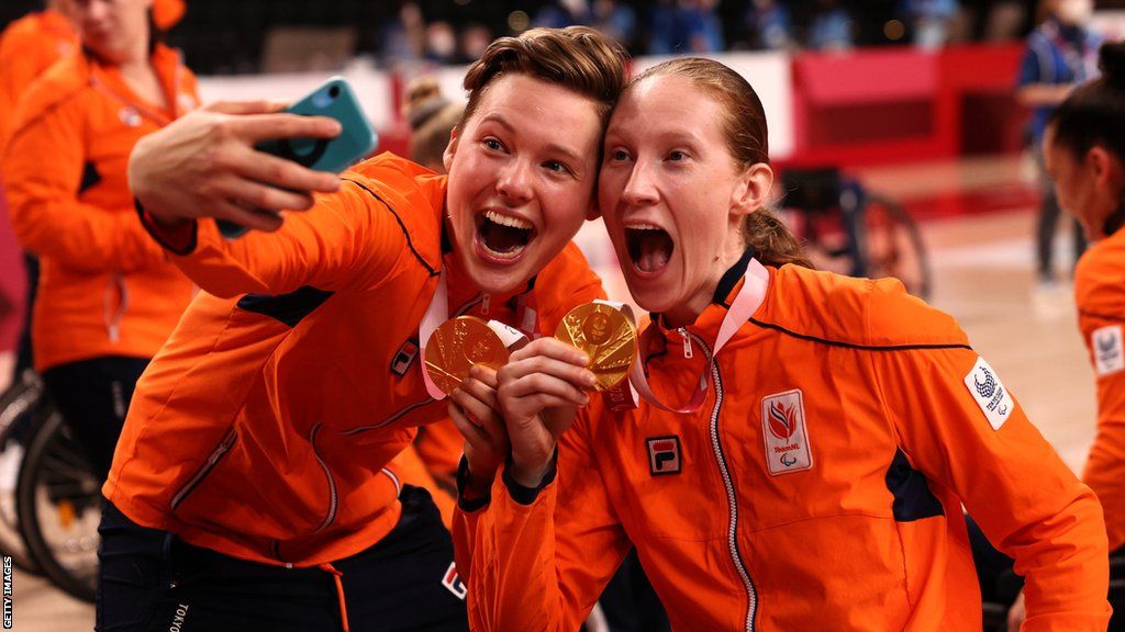 Bo Kramer (left) with one of her Dutch team-mates holding their Paralympic gold medals
