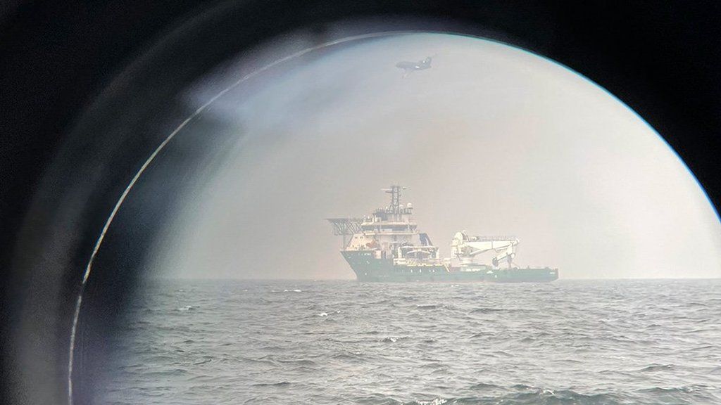 Russian vessel Nefrit and Danish surveillance plane viewed through binoculars