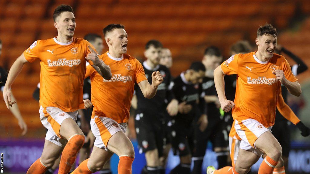 Blackpool players celebrate their penalty shootout victory over Bolton Wanderers at Bloomfield Road