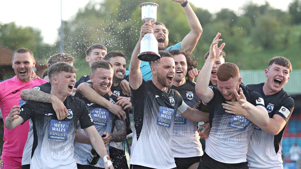 Haverfordwest players celebrate after their play-off against Newtown, which was decided on penalties