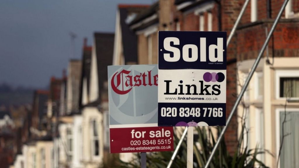 For sale signs line a street