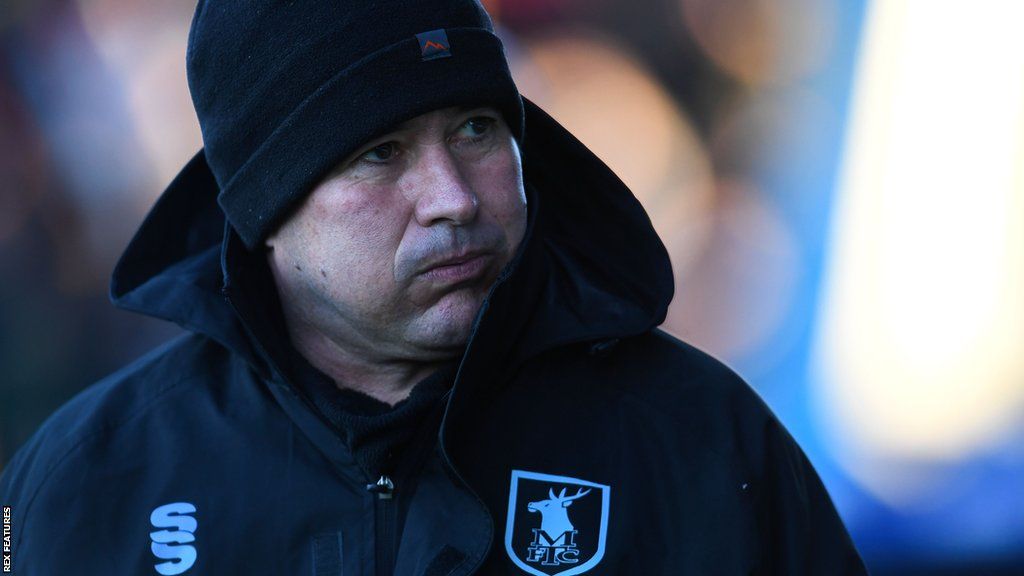 Mansfield boss Nigel Clough watches on from the sidelines