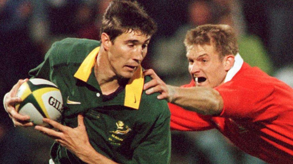 South African wing Pieter Rossouw evades a tackle from Wales' Dafydd James