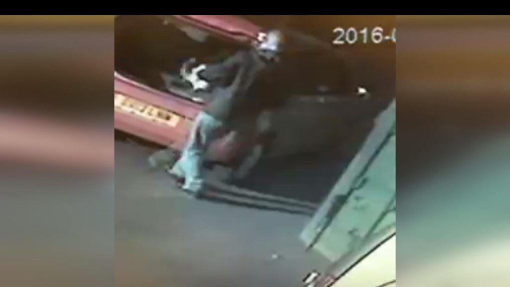 CCTV footage of man filling red car with stolen animal food