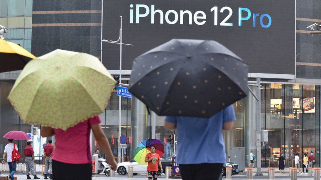An iPhone 12 Pro logo seen displayed on a large screen outside the Apple store on Wangfujing Street in Beijing.