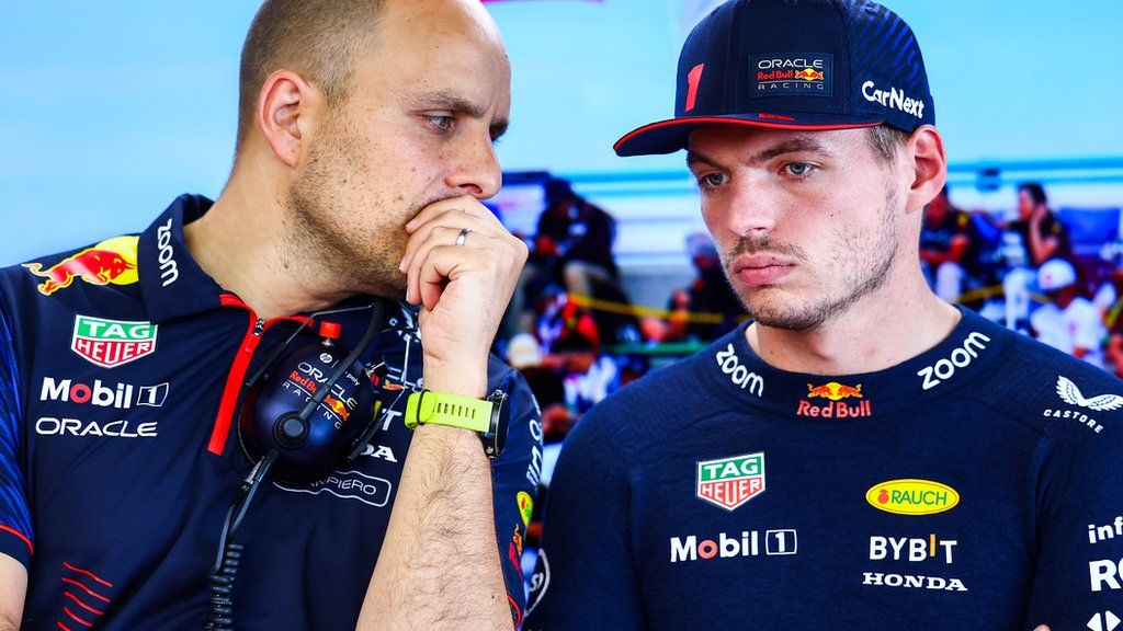 Gianpiero Lambiase and Max Verstappen stand talking in the Red Bull garage