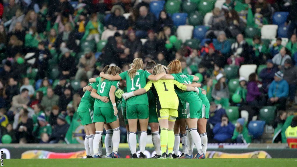 Northern Ireland players form a huddle at Windsor Park prior to the 5-0 defeat by England in April 2022