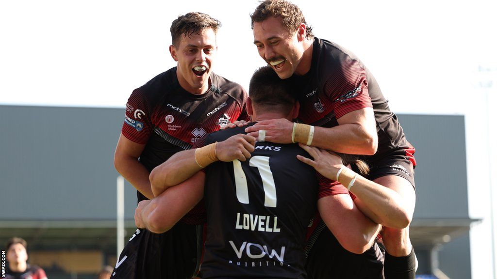 London Broncos players celebrate a try against Toulouse