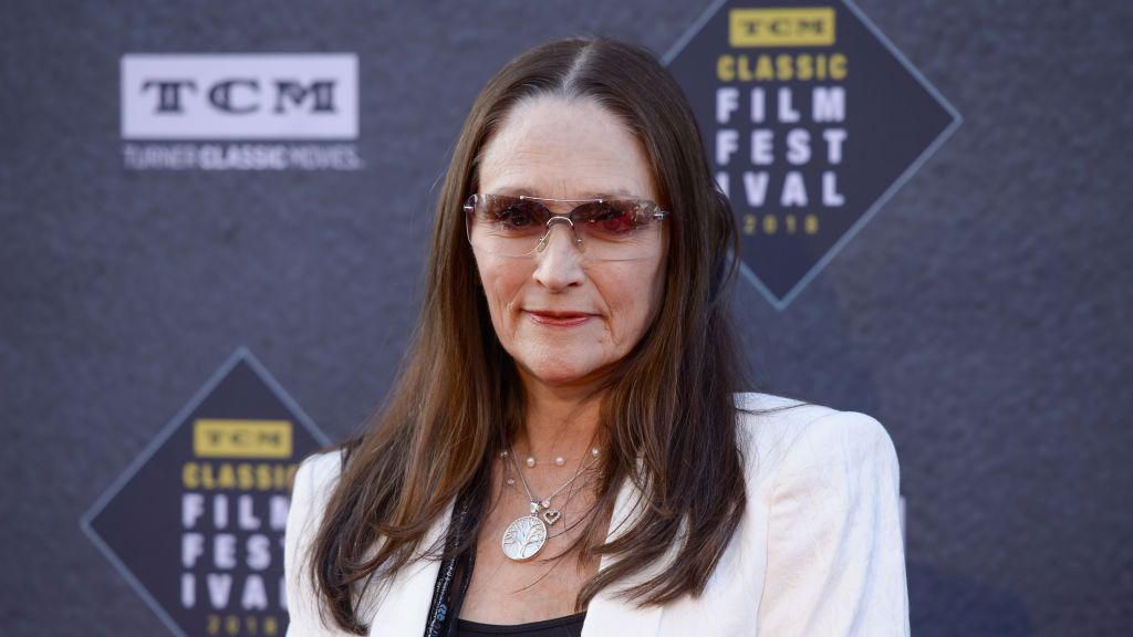 Olivia Hussey wears sunglasses and a white blazer on the red carpet of the TCM Classic Film Festival in 2018