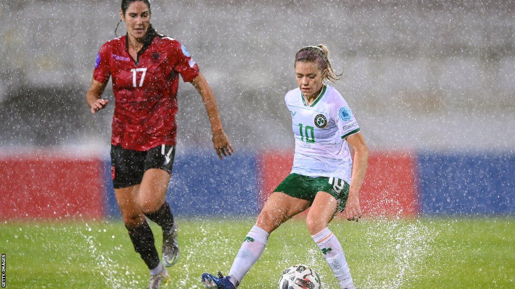 The Republic of Ireland's Denise O'Sullivan attempts to control the ball on the waterlogged pitch as Albania's Kristina Maksuti is about to make a challenge