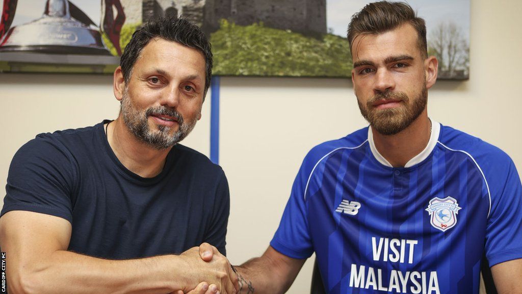Erol Bulut (L) welcomes Dimitrios Goutas to Cardiff City