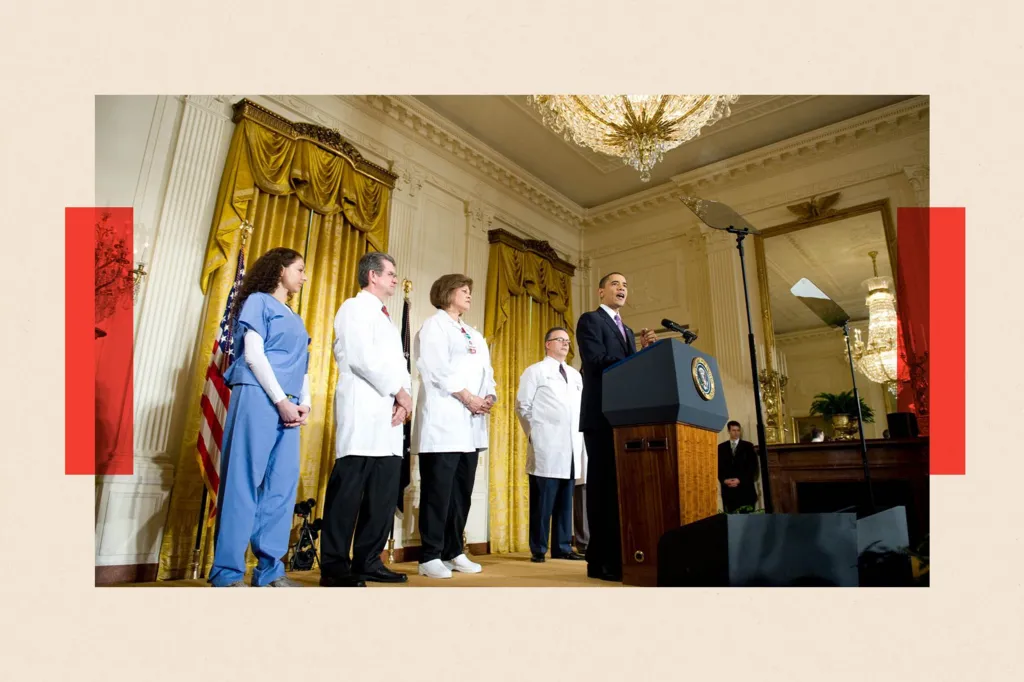 Three people in white medical coats, and one woman wearing blue hospital scrubs, stand behind Barack Obama on a stage in the White House East Room as he makes a policy announcement
