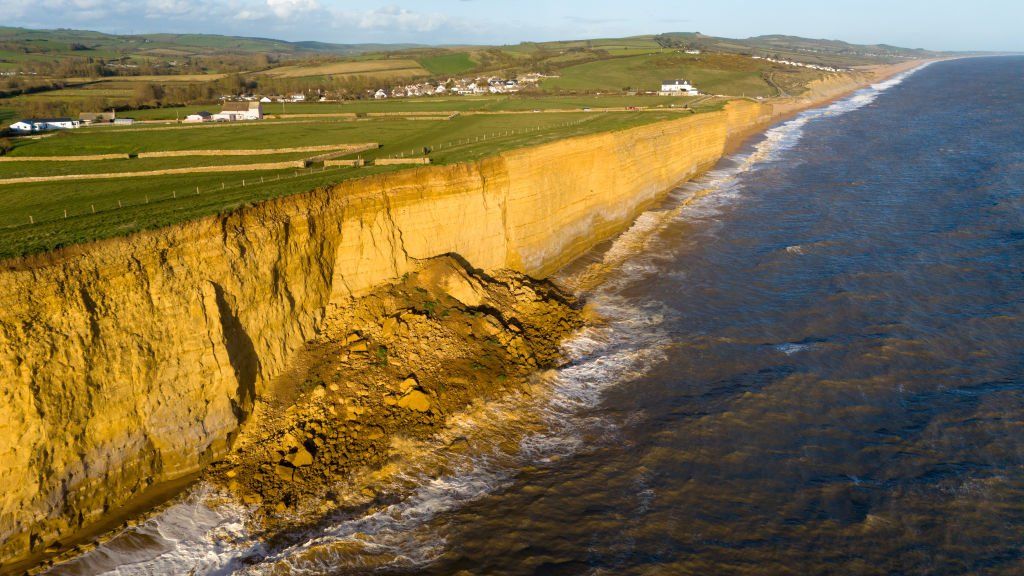 An aerial view of a large cliff fall at Hive Beach