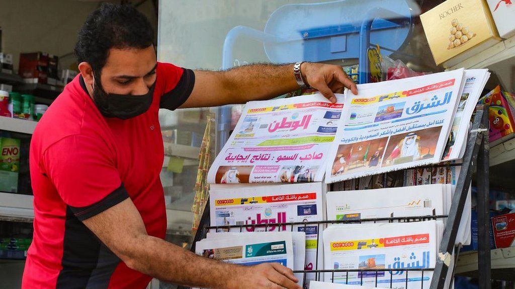 A man arranges newspapers in the Qatari capital Doha, January 2021