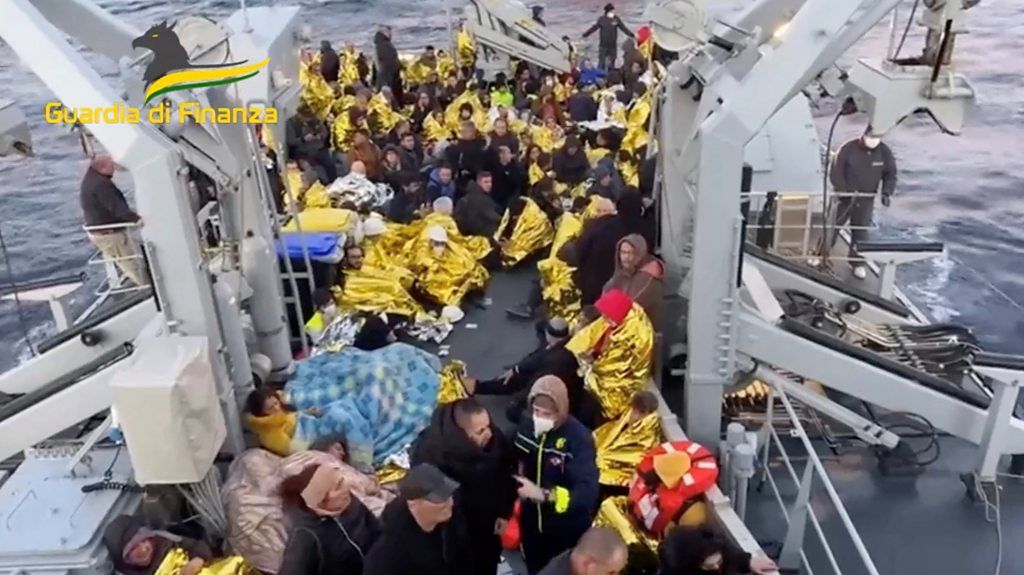 People sat on floor of lifeboat