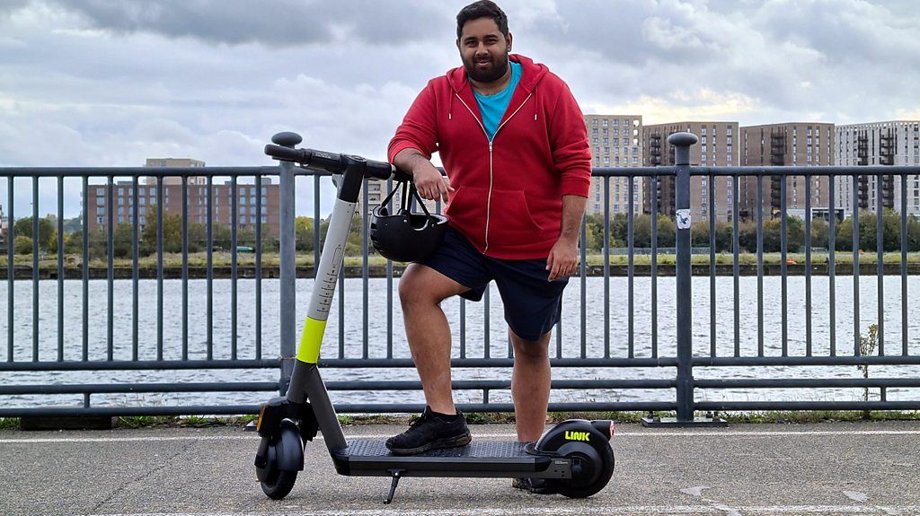 Reporter Omar Mehtab on a scooter