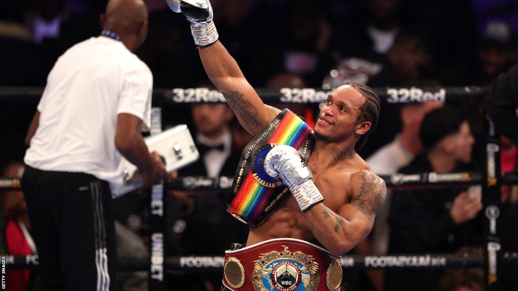 Anthony Yarde looks to the sky with his belts on his shoulder