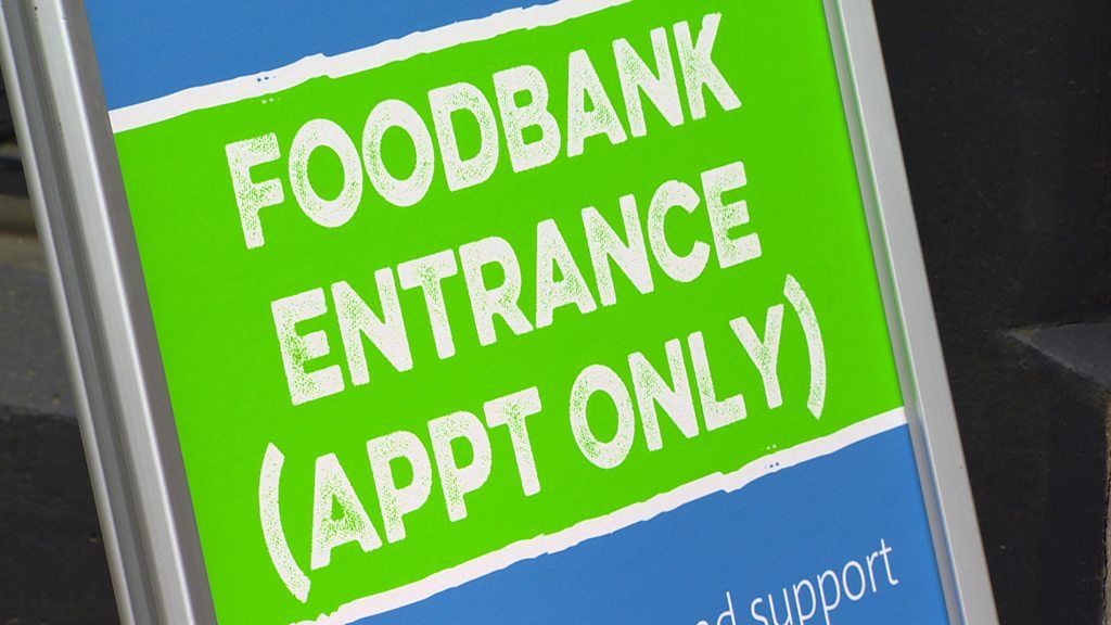 A sign that reads: Foodbank entrance (appointment only)