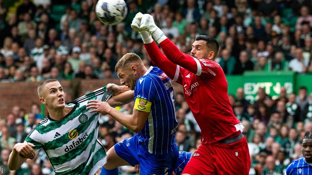 St Johnstone's Dimitar Mitov (right) punches clear