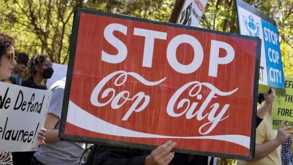 Protesters opposed to the facility marching in Atlanta earlier this year with a sign saying "Stop Cop City"