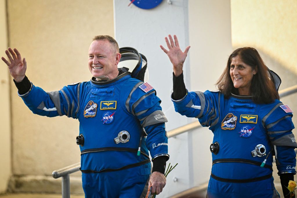 Astronauts Suni Williams and Butch Wilmore waveas they prepare to depart  at Kennedy Space Center 