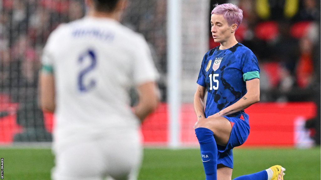 Megan Rapinoe takes a knee prior to a friendly against England
