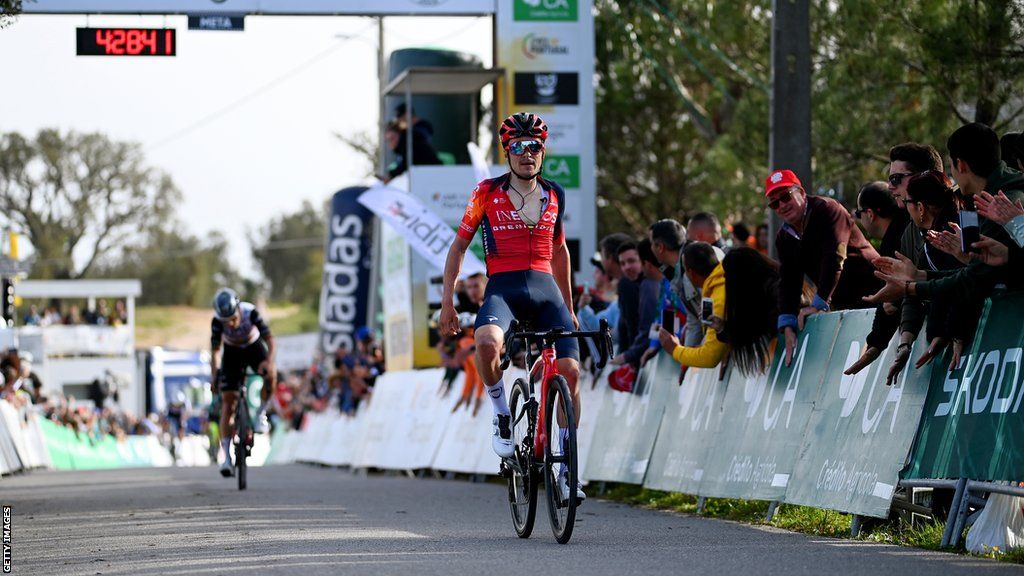 Tom Pidcock rides across the finish line in Portugal
