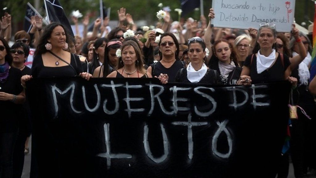 Women in black protesting in Chile
