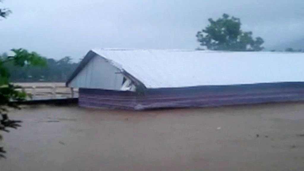 Still of longhouse being swept away
