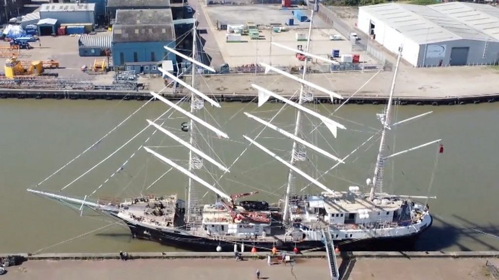 The drone pictures show SV Tenacious docked in a town as part of its circumnavigation of the UK.