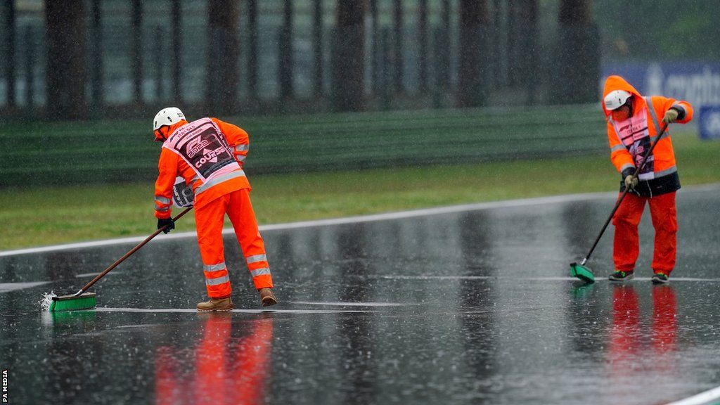 Stewards try to clear water from track
